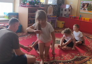 Dzieci wykonują ćwiczenia gimnastyczne.