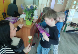 Chłopcy wręczają kwiatka cioci.