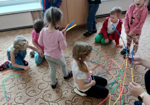 Dzieci tworzą konstrukcję z klocków.