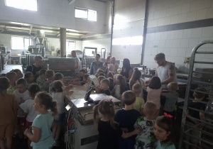 Dzieci w piekarni obserwują produkcję pieczywa.