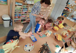 Dzieci tworzą postacie z dyni.