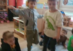 Dzieci bawią się z pluszowym misiem z okazji jego święta.