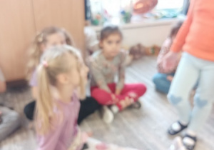 Dzieci bawią się z pluszowym misiem z okazji jego święta.