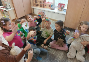 Dzieci bawią się z pluszowym misiem z okazji jego święta.