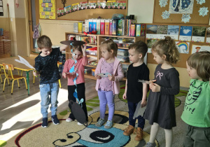 Dzieci trzymają elementy pogodowe.