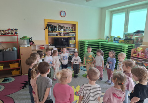 Dzieci w kole śpiewają sto lat.