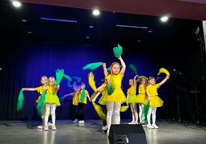 Dzieci w żółtych koszulkach na scenie podczas występu w MOKu.