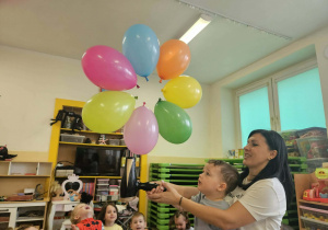 Ciocia dmucha suszarką w balony.