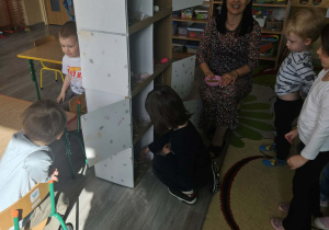 Dzieci przeliczają jajka w kurniku.