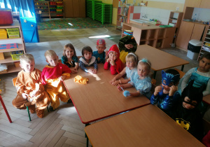 Dzieci siedzą przy stoliku.