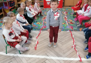 Dzieci ubrane na biało-czerwono biorą udział w pokazie mody patriotycznej.