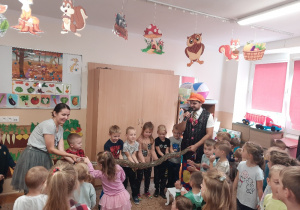 Dzieci trzymają na rękach węża.