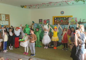 Dzieci w sali przedszkolnej przedstawiają przedszkolakom inscenizację wiersza "Rzepka"